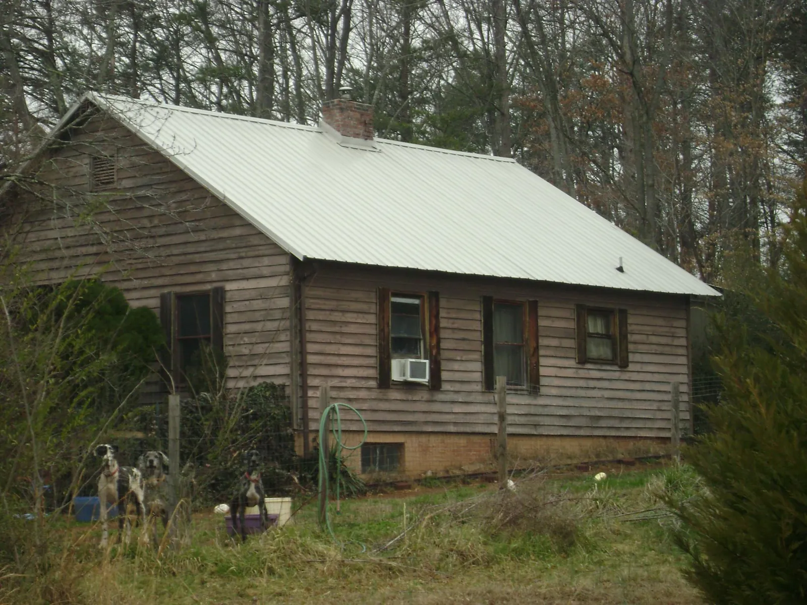 White metal roof on an old wood sided farmhouse, from a Metal Roof Installation job in Parrott